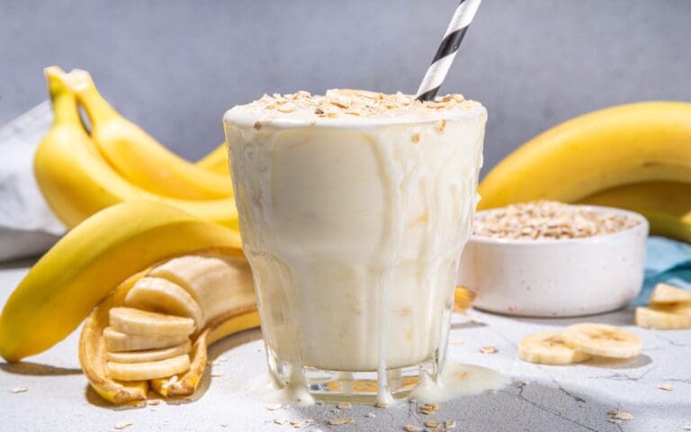 banana milkshake with whole bananas in background