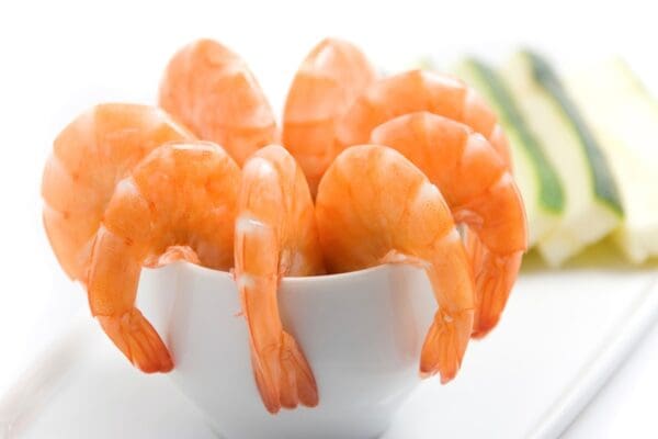 Cooked shrimp cutlets arranged on a white plate, showcasing their golden-brown exterior and succulent interior.